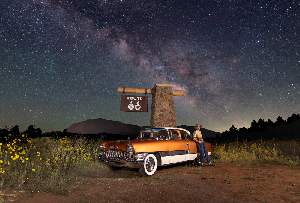 Posing with a classic car and Route 66 sign on a starry night in Flagstaff, Arizona Posing with a classic car and Route 66 sign on a starry night in Flagstaff, Arizona