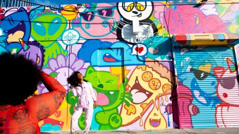 Posing in front of street art in the creative district of Wynwood