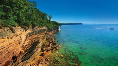Signature sandstone cliffs hugging the shore of Lake Superior