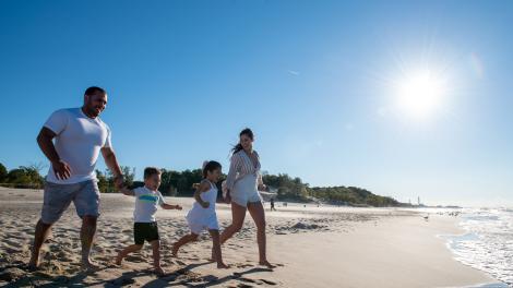Family running on the beach in the Indiana Dunes region