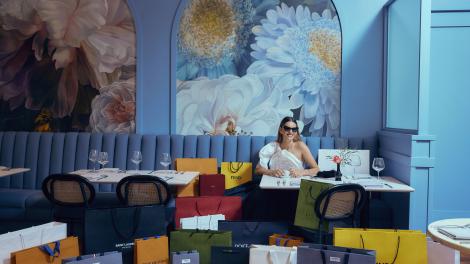 A shopper surrounded by colorful shopping bags at South Coast Plaza in Costa Mesa, California A shopper surrounded by colorful shopping bags at South Coast Plaza in Costa Mesa, California