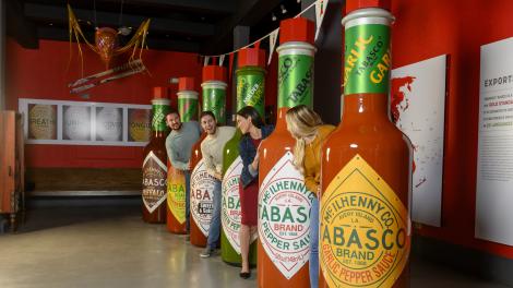 Posing with life-sized TABASCO hot sauce bottles on the TABASCO Brand Factory Tour & Museum in Avery Island, Louisiana
