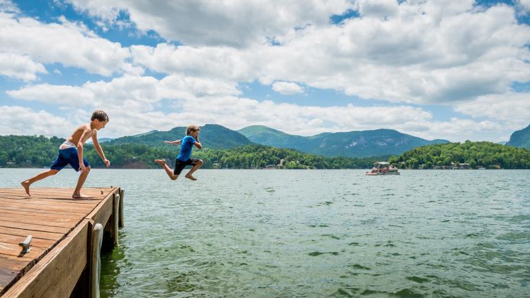 Children leap off a dock at Lake Lure 