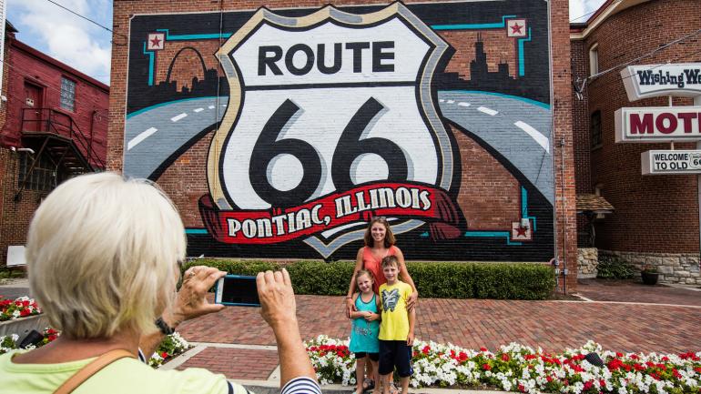 Posing in front of the classic Route 66 mural in Pontiac, Illinois