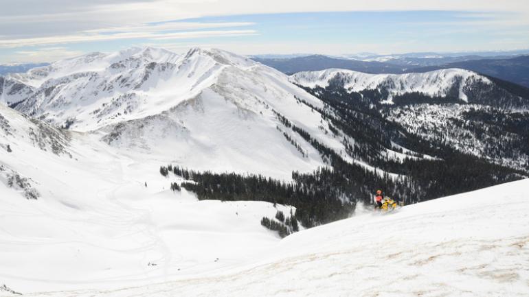 Snowmobile adventures on a winter day in mountains surrounding Grand Lakes