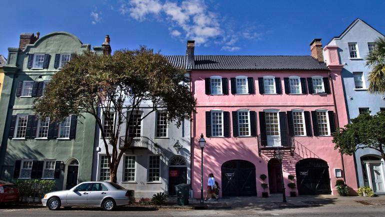 Strolling alongside the colorful houses known as ‘Rainbow Row’ in Charleston, South Carolina