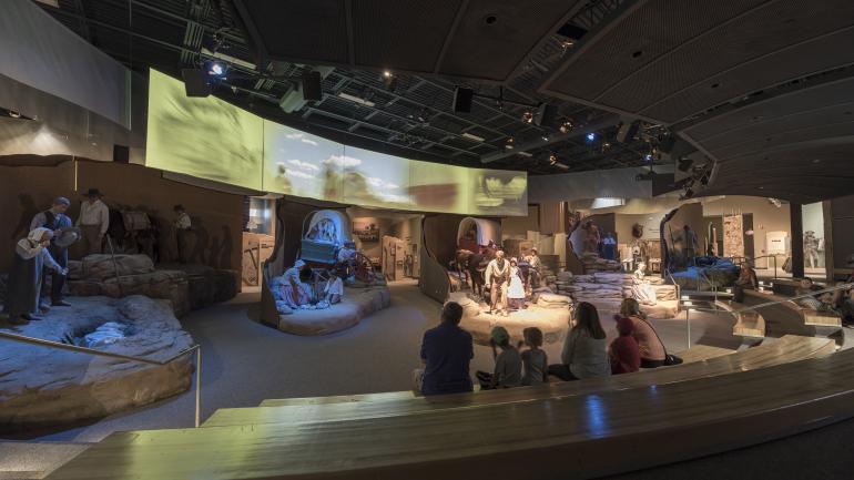 キャスパーにある国立歴史トレイル・インタープリティブ・センターで展示物を見学する家族連れ