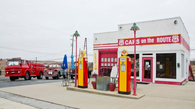 Service station and car garage painted white with red doors and trim known as Cars on the Route in Galena, Kansas