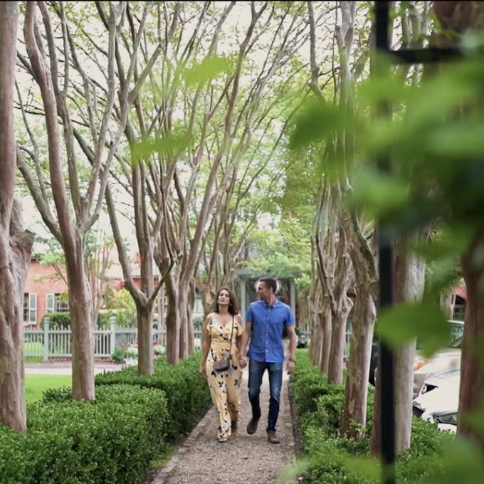 Couple strolls a tree-lined boulevard in South Carolina Couple strolls a tree-lined boulevard in South Carolina