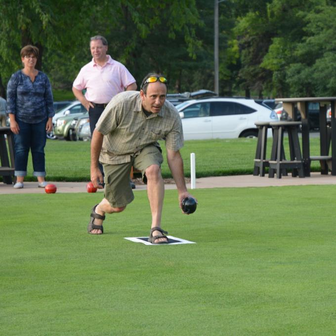 Bowler preparing to roll his jack down the green at Brookview Golf & Lawn Bowling in Golden Valley, Minnesota