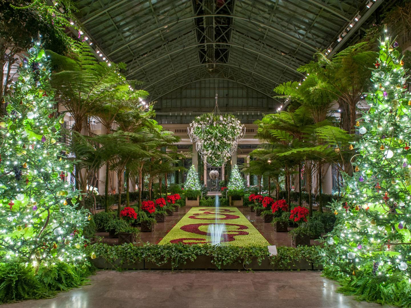 Holiday decorations light up the grand interior during A Longwood Christmas