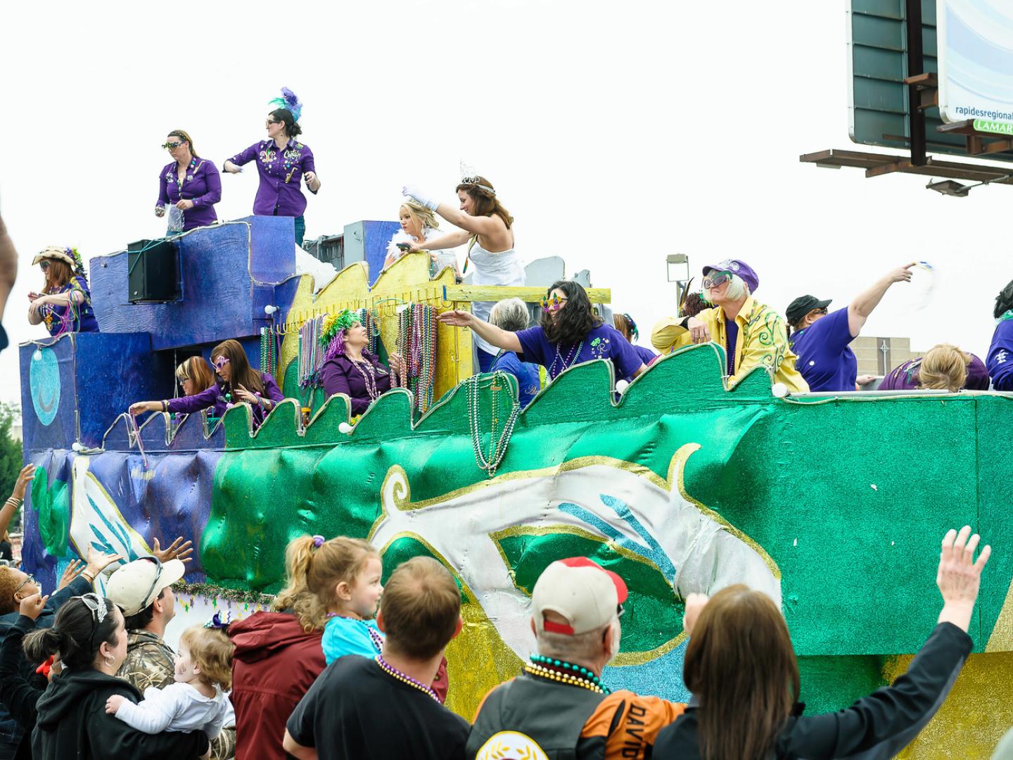 Catching beads from a float at Mardi Gras
