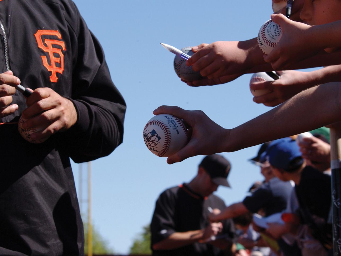 Waiting for autographs from members of the MLB’s San Francisco Giants during spring training in Scottsdale, Arizona
