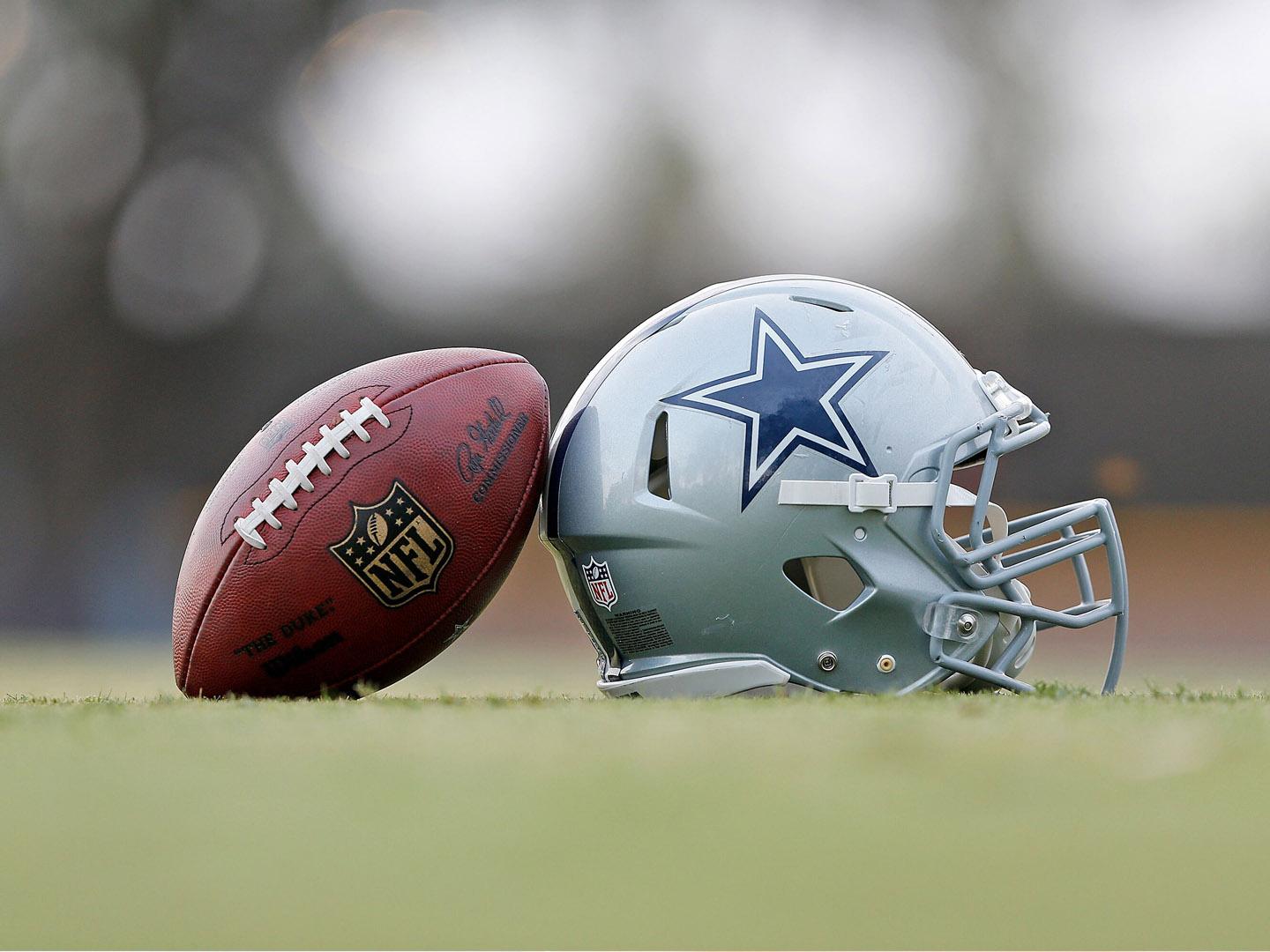 A football and a Dallas Cowboys helmet at the training center in Oxnard, California