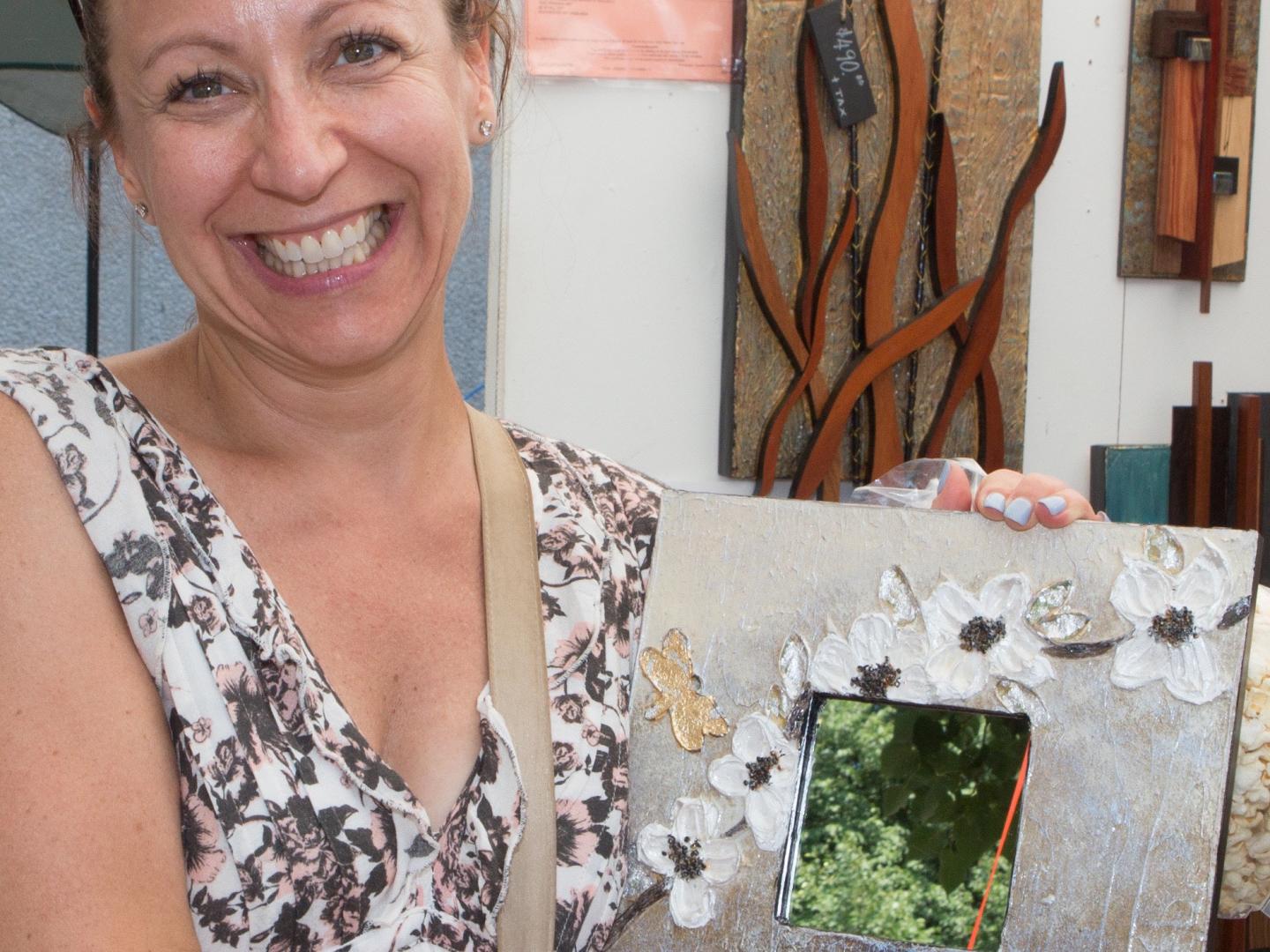 Un artista muestra una pintura en Corn Hill Summer Arts Festival en Rochester, Nueva York