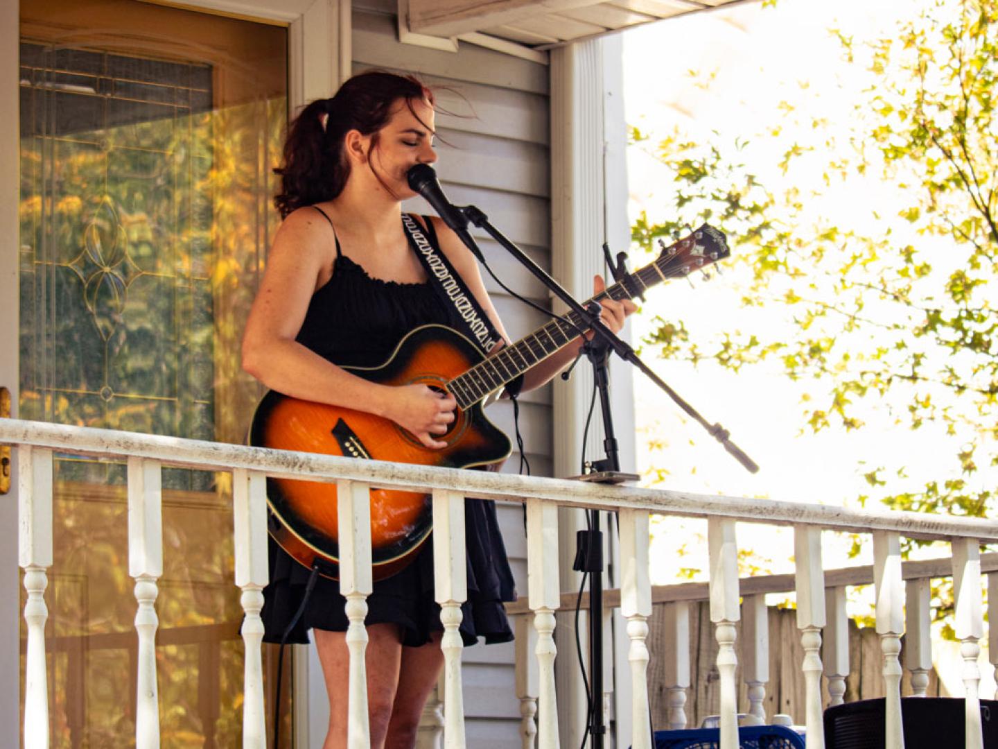 A singer and guitarist performs during North Heights Porchfest in Joplin, Missouri