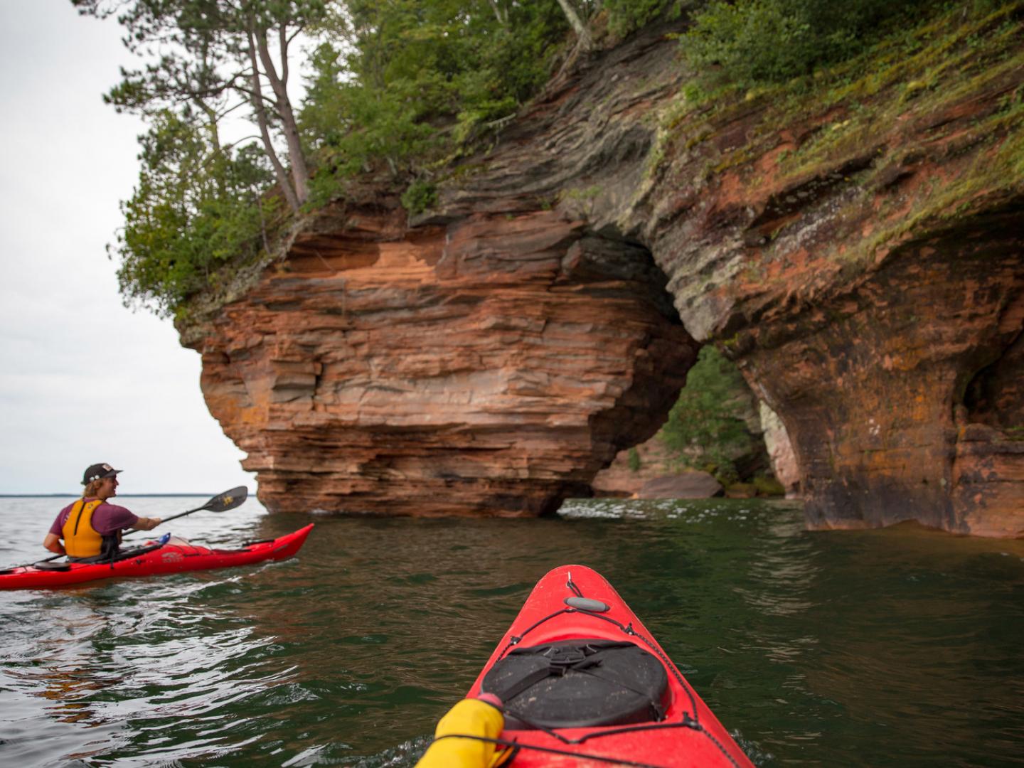 Kayaking along the rocky shore of Apostle Islands National Lakeshore in Wisconsin