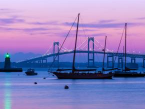 Purple sunset over Newport Bridge and Goat Island Lighthouse Purple sunset over Newport Bridge and Goat Island Lighthouse