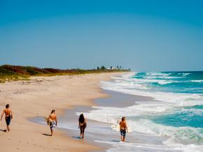 Surfers strolling along one of the area’s 115 kilometers of beaches Surfers strolling along one of the area’s 115 kilometers of beaches