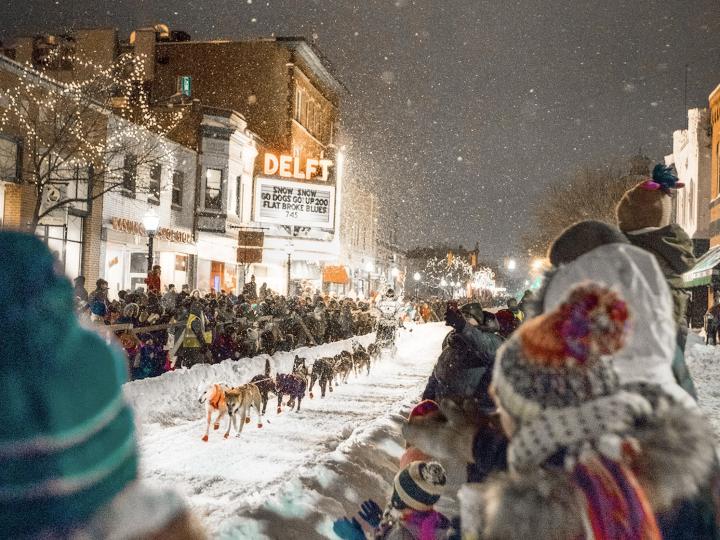 A sled dog team racing through downtown Marquette, Michigan, during the UP200