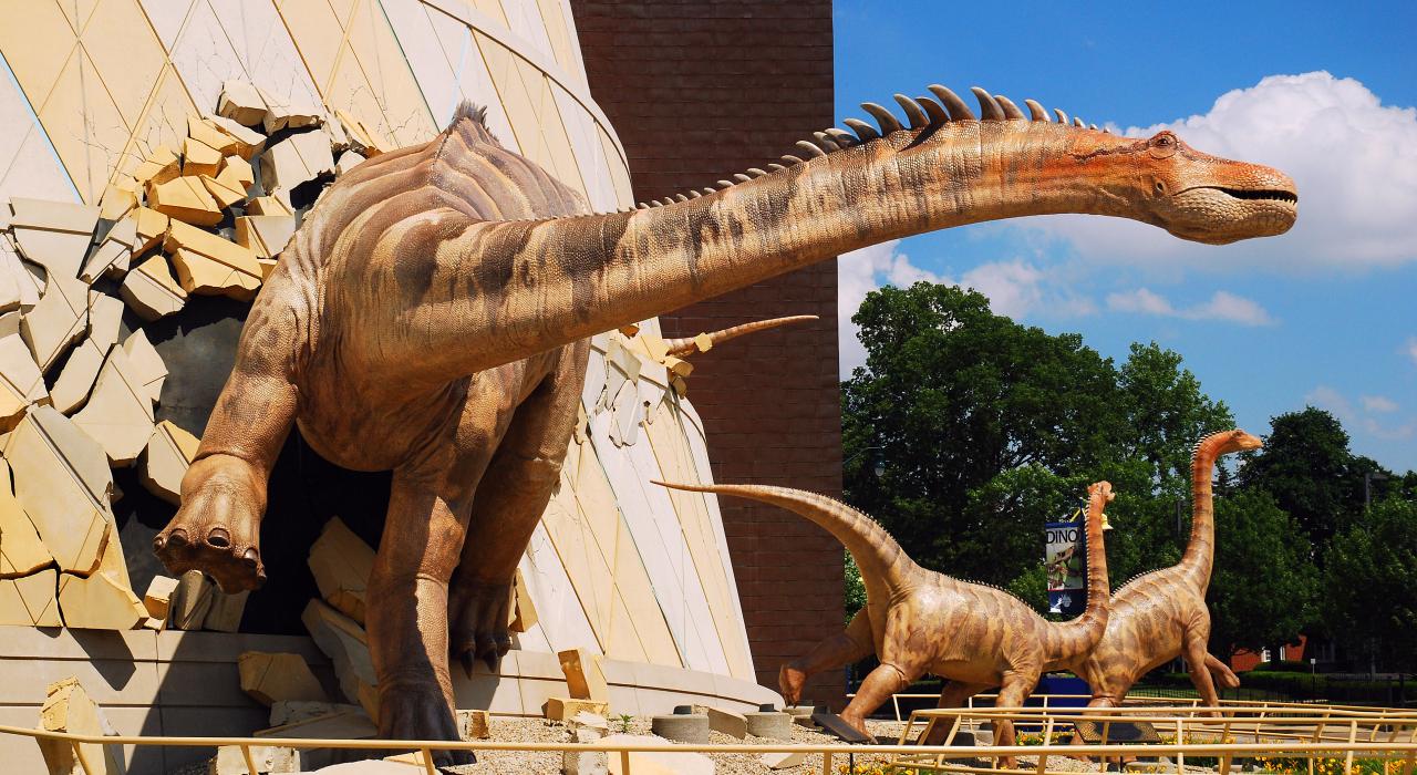 A dinosaur "breaks out" of the wall at the Children's Museum of Indianapolis