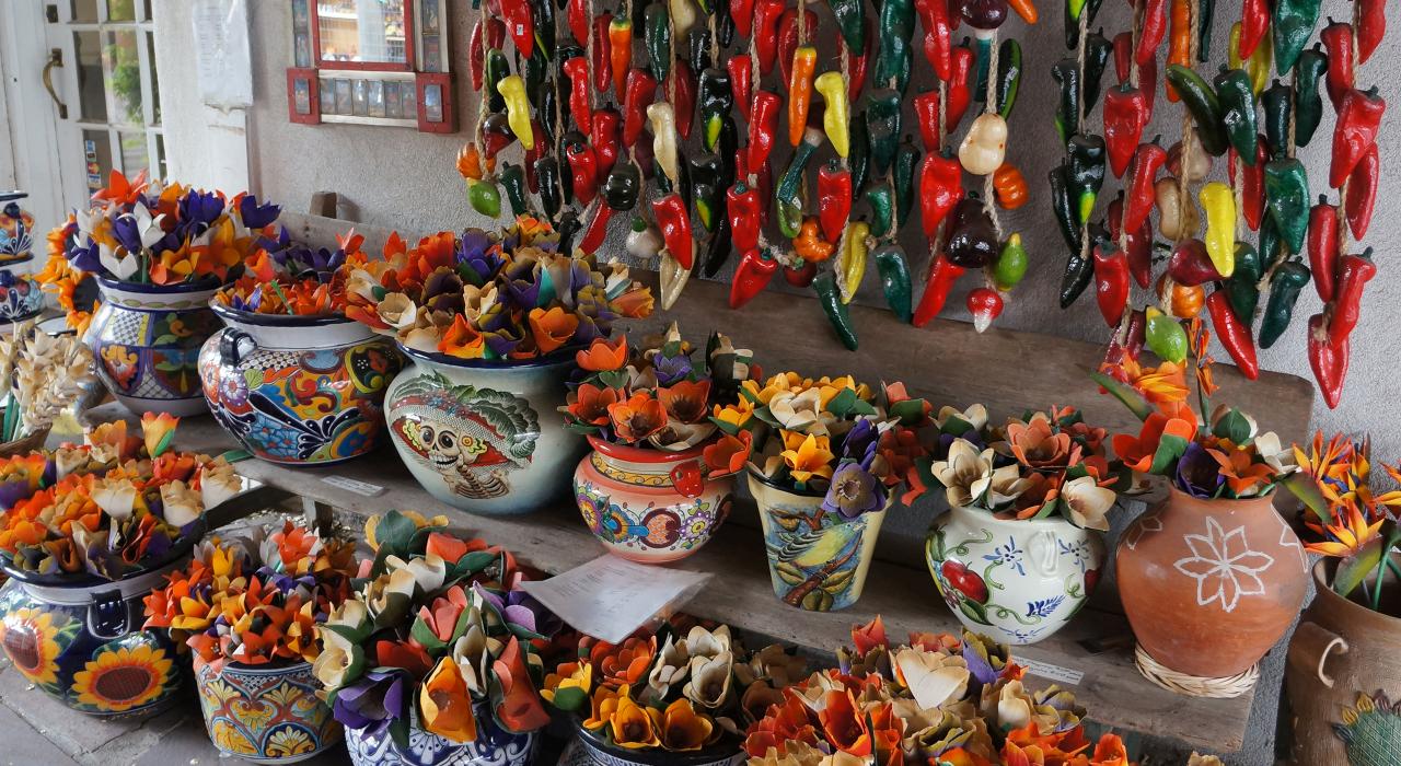 Flowers and dried chilis in colorful earthenware pots