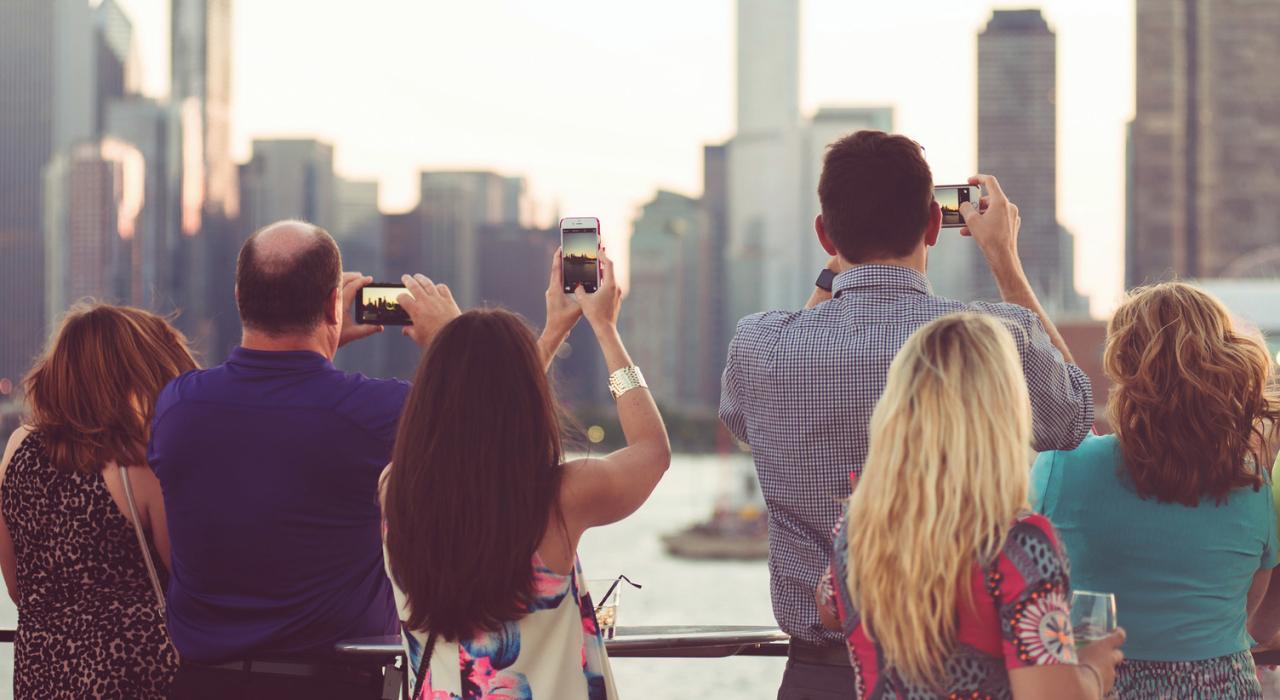 Passengers admiring the skyline from an Odyssey Cruise 