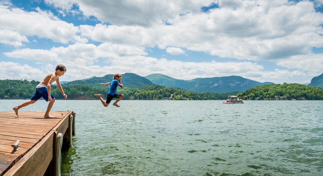 Children leap off a dock at Lake Lure 