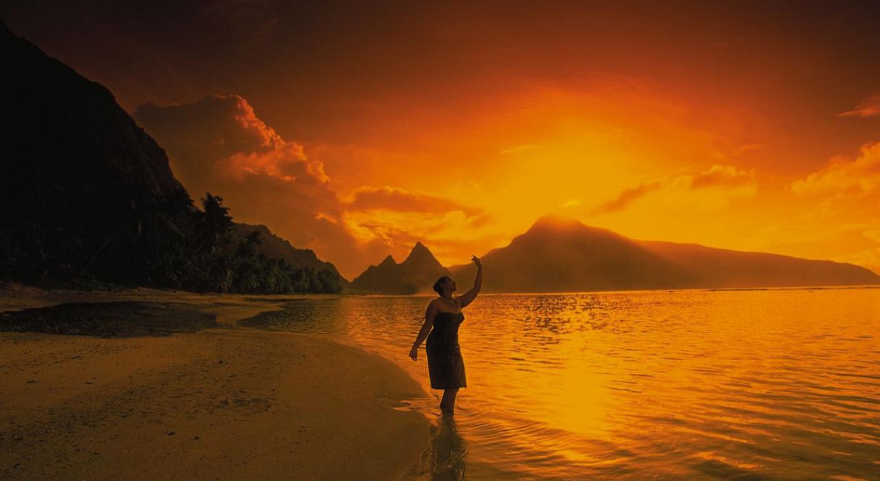 Rising sun over the mountains and coastline of the Manu'a Islands