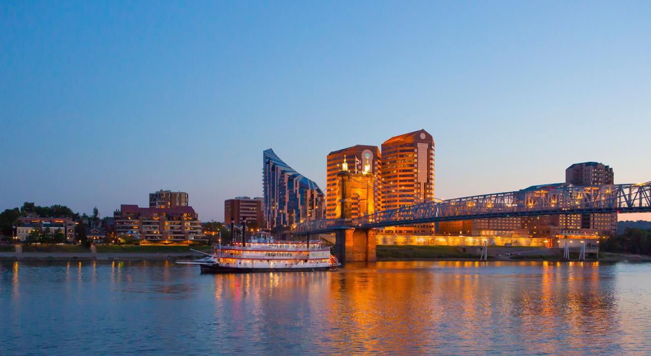 A riverboat cruise on the Ohio River with the Covington skyline beyond