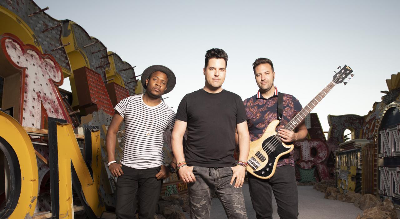 Frankie Moreno and his band posing at the Neon Museum in Las Vegas, Nevada