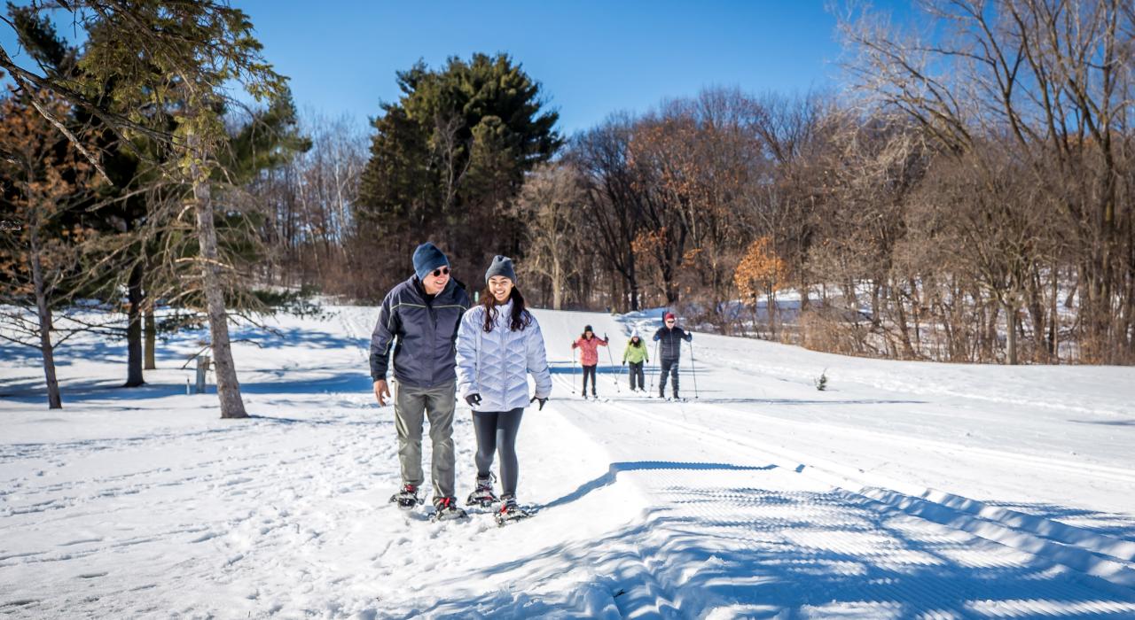 Snowshoeing and skiing on trails at Theodore Wirth Regional Park