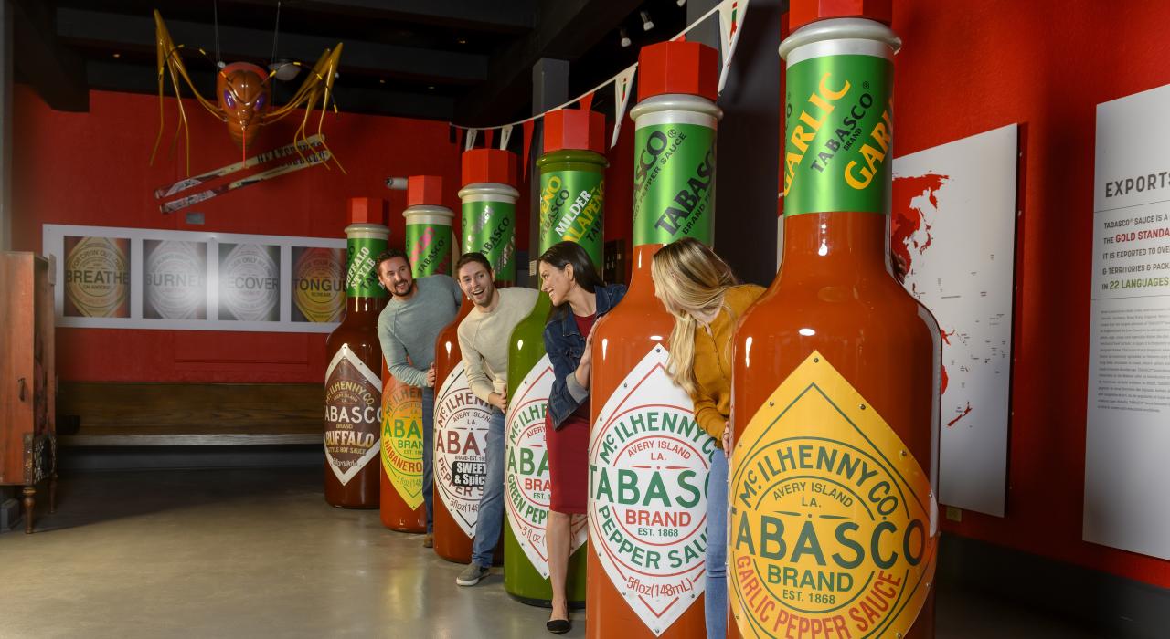 Posing with life-sized TABASCO hot sauce bottles on the TABASCO Brand Factory Tour & Museum in Avery Island, Louisiana